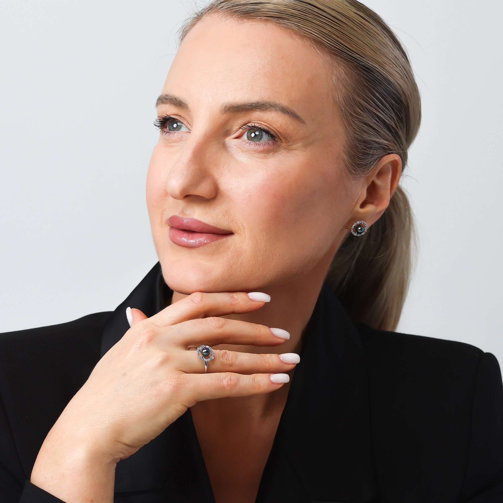 Woman wearing a black blazer with a neutral background