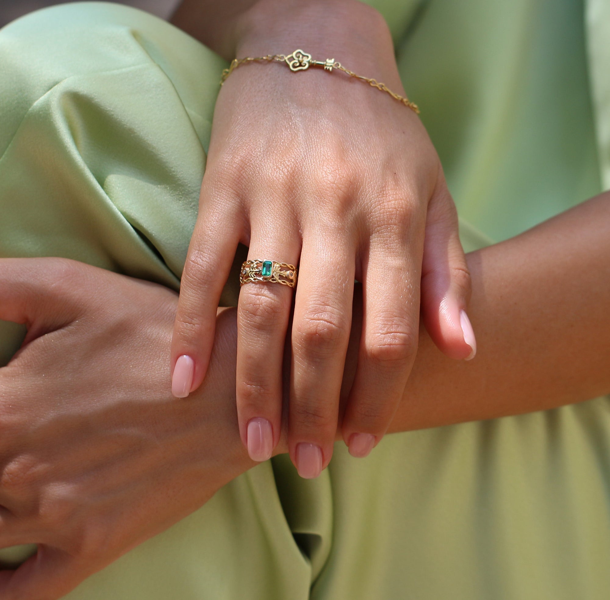 Marilisi emerald and diamond gold openwork ring worn by model in green suit, artisan fine jewelry for collectors