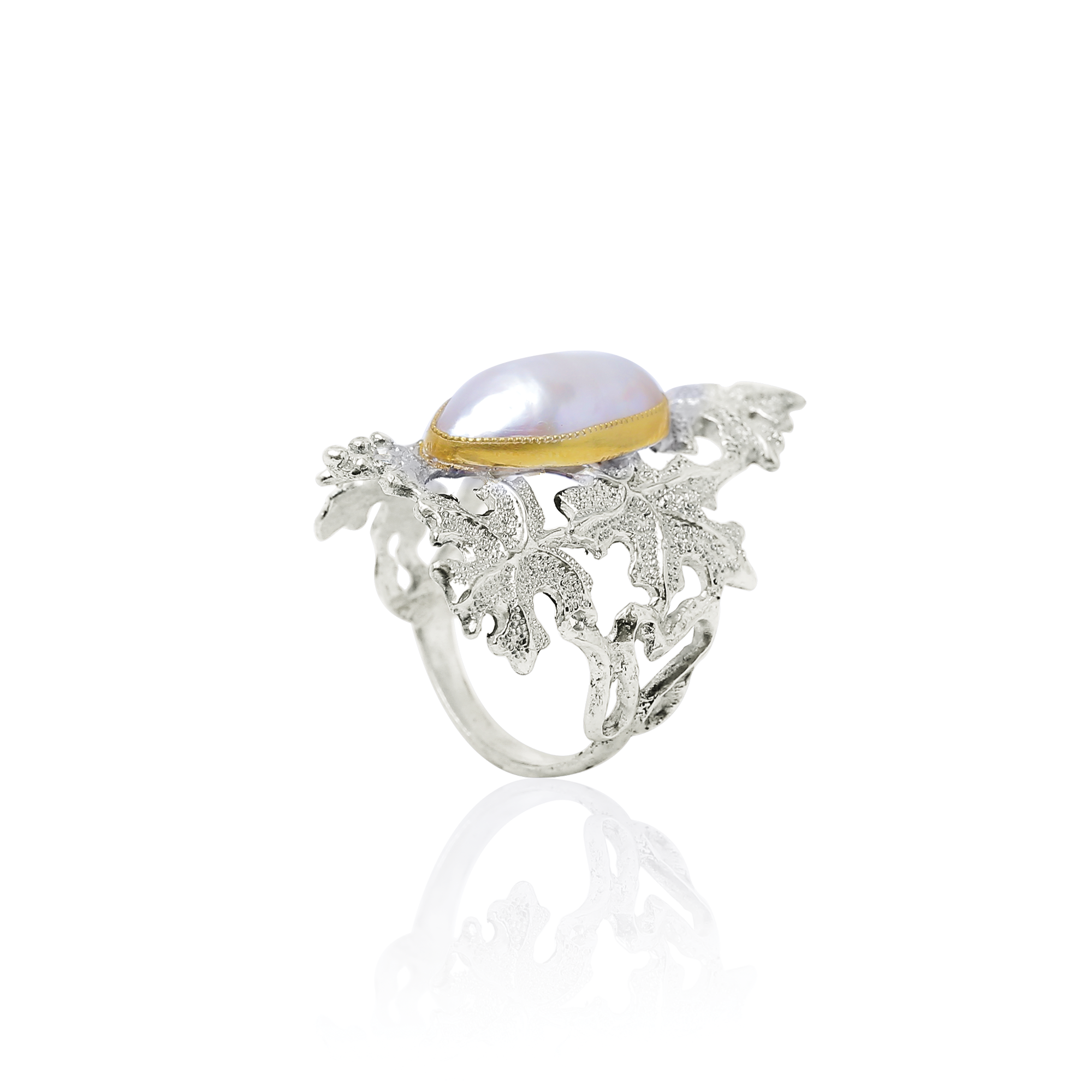 Silver ring with a pearl and gold accent on a white background
